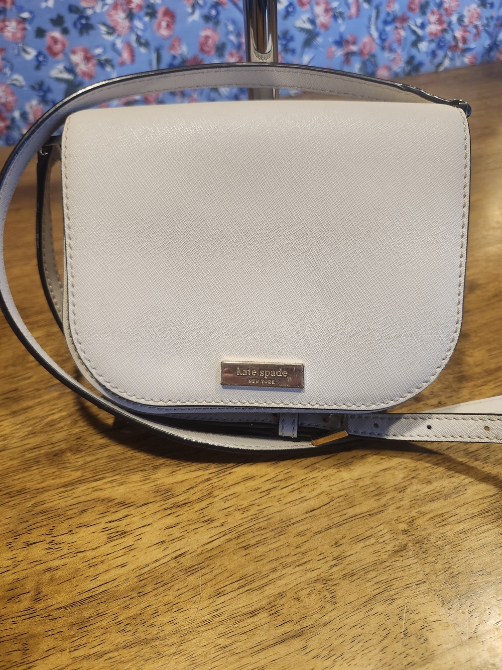 kate spade cream crossbody with gold-tone logo plaque